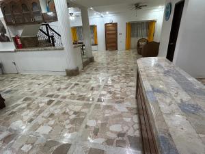 a living room with a stone floor and a table at G Apartment - Standard Room in Binicuil