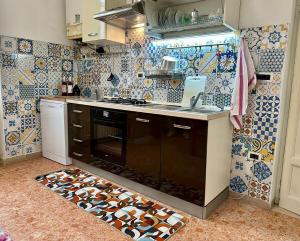 a kitchen with blue and white tiles on the wall at House 130 Francavilla B&B in Francavilla al Mare