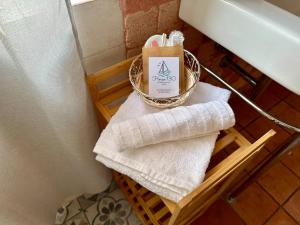a bathroom with a basket of towels and a candle at House 130 Francavilla B&B in Francavilla al Mare +4 photos
