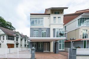 a house with a white fence in front of it at Tanjung Bungah Villa 20 pax Mahjong Snooker and More Close to Beach in Tanjung Bungah
