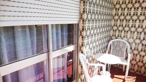 a balcony with a table and chairs and a window at Casa Quinta da Adega do Chão - Vale do Douro in Lamego