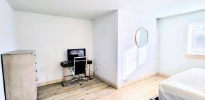 a white bedroom with a bed and a mirror at Coastal Adventures, Lake, Ocean, Casinos, Hiking in Neotsu