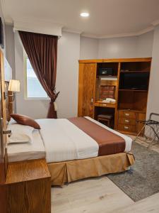 Postel nebo postele na pokoji v ubytování Travellerinn Serviced Apartment