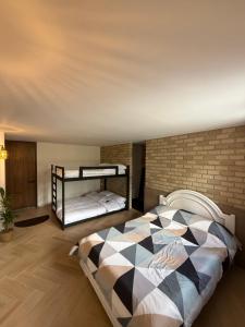 a bedroom with a bed and a brick wall at Alma House in Monguí