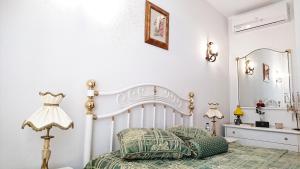 a white bedroom with a bed and a mirror at Casa Quinta da Adega do Chão - Vale do Douro in Lamego