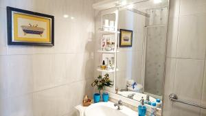 a bathroom with a sink and a shower with a mirror at Casa Quinta da Adega do Chão - Vale do Douro in Lamego