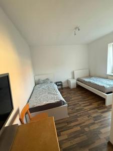 a bedroom with a bed and a flat screen tv at Ferien- und Monteurwohnungen Nähe Leipzig & A72 in Böhlen +3 photos