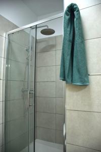 a shower with a green towel hanging on a wall at Casa Mirasol in Playa de San Juan +18 photos