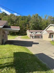 a driveway in front of a house at Economy Inn in Alfred