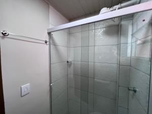 a shower with a glass door in a bathroom at Apartamento novo próximo a Av do CPA in Cuiabá +12 photos