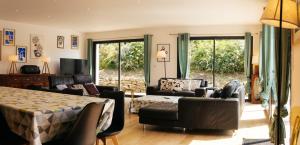 a living room with a bed and a couch at Maison de Saint-Jean in Fouesnant