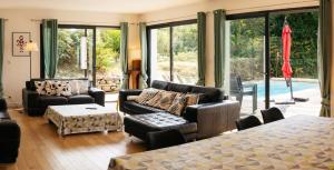 a living room with a couch and a table at Maison de Saint-Jean in Fouesnant