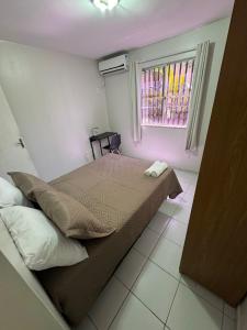 Ένα ή περισσότερα κρεβάτια σε δωμάτιο στο Apartamento 2 quartos próximo a praia do araçagy +2 φωτογραφίες