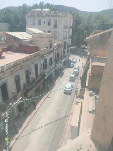 an overhead view of a city street with cars on the road at Centre ville place in Tlemcen