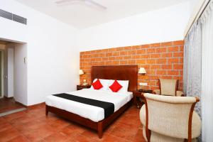 a bedroom with a bed and a brick wall at Super Townhouse Island Inn in Cochin