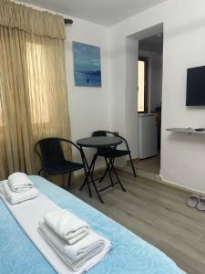 a room with a bed and a table and chairs at Vila di Marko & Nati in Pogradec +14 photos