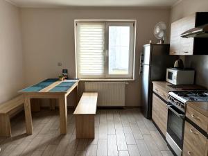 a small kitchen with a table and a refrigerator at Kamienica pod Rakiem in Żmigród +7 photos