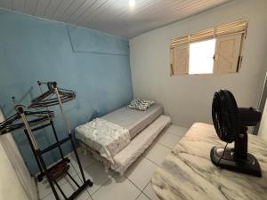 a room with a room with a bed and a window at Casinha Sol e Mar in Extremóz