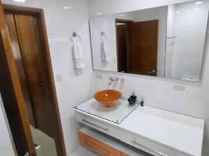 a bathroom with a sink with a bowl on a counter at Guest house with AC close to Historical Centre 2 in Cartagena de Indias