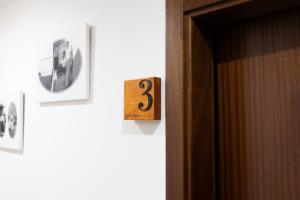 an open door with a number three on the wall at Casa de l' Eigreija in Vila de Ala