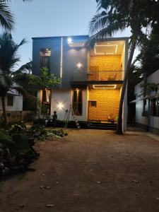 a yellow brick house with a palm tree in front of it at 3bhk luxury Villa in Taingapatam