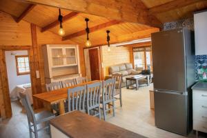 a kitchen and dining room with a table and a refrigerator at Casa Tita Mari in Jaén