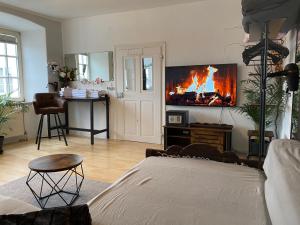 a living room with a couch and a fire on the wall at Schlafen wie Prinzessinen in Kempten Schlösschen in Kempten