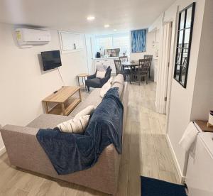 a living room with a couch and a dining room at Cozy 2BR - Backyard Fun and Dog Friendly - sleeps 6 in Vancouver