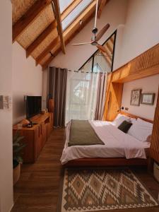 a bedroom with a large bed and a television at abode II Zanzibar in Paje +45 photos