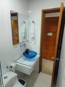 a bathroom with a blue sink and a toilet at Guest House with AC, close to Historical Centre 3 in Cartagena de Indias