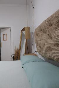 a bedroom with a bed with a headboard and a lamp at La Casita in Cenes de la Vega