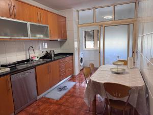 a kitchen with a table and a dining room at Jose s place in Alfena