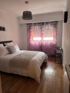 a bedroom with a large bed and a window at Jose s place in Alfena