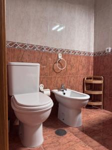 a bathroom with a toilet and a sink at Jose s place in Alfena +15 photos