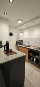 a kitchen with a sink and a counter top at DG Rosa María in Santiago del Estero +9 photos