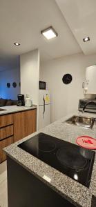 a kitchen with a counter top and a refrigerator at DG Rosa María in Santiago del Estero