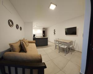 a living room with a couch and a table at DG Rosa María in Santiago del Estero