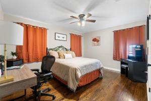 a bedroom with a bed and a desk with a computer at Escape by Beaches & Blue Angels in Pensacola +44 photos