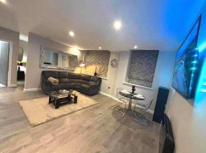 a living room with a couch and a table at Apartment in south yorkshire Central location in Barnsley