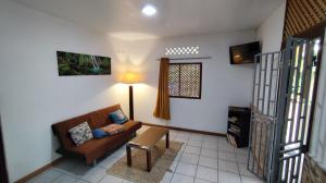 a living room with a couch and a table at MO TI KOTÉ in Cayenne