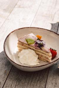 a plate with a piece of cake and a strawberry at Vitalhotel Kaiserhof in Seefeld in Tirol +87 photos