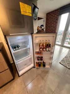 a refrigerator with its door open in a kitchen at Uleu Zona Viva in Guatemala