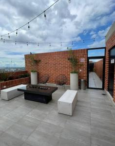 a patio with a table and benches on a brick building at Uleu Zona Viva in Guatemala