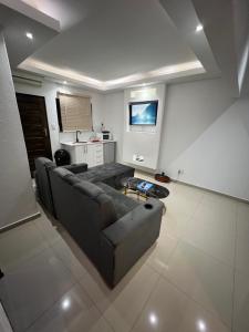 a living room with a couch and a tv at Made Stays in Four Ways