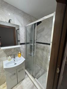 a bathroom with a shower and a sink at stone house marathounta in Marathounda +6 photos