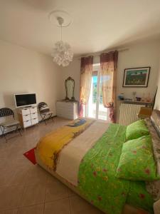 a bedroom with a large bed and a television at Skyline Appartamento Lella in Acqui Terme