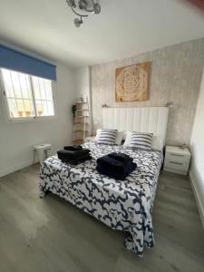 a bedroom with a bed with two black bags on it at Casa Maja in Costa de Antigua +23 photos