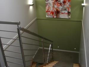
a stairway leading up to a room with stairs at Chaucer Palms Boutique B&B in Newcastle
