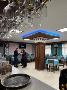 a group of people standing in a dining room at Gelov Hotel in Berkovitsa