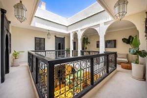 a home with a balcony with a lion painted on the gate at Riad Nayl Medina & Spa in Marrakech